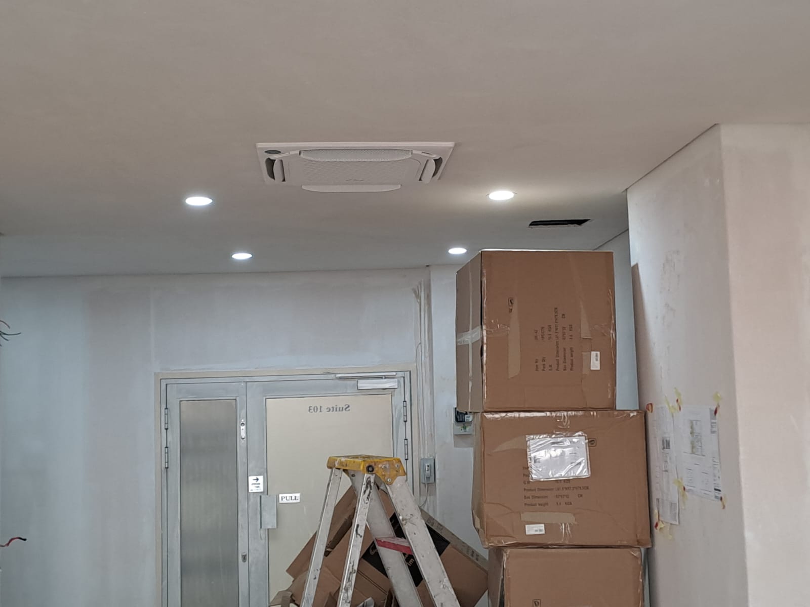 Office ceiling cassette air conditioner unit installation during construction