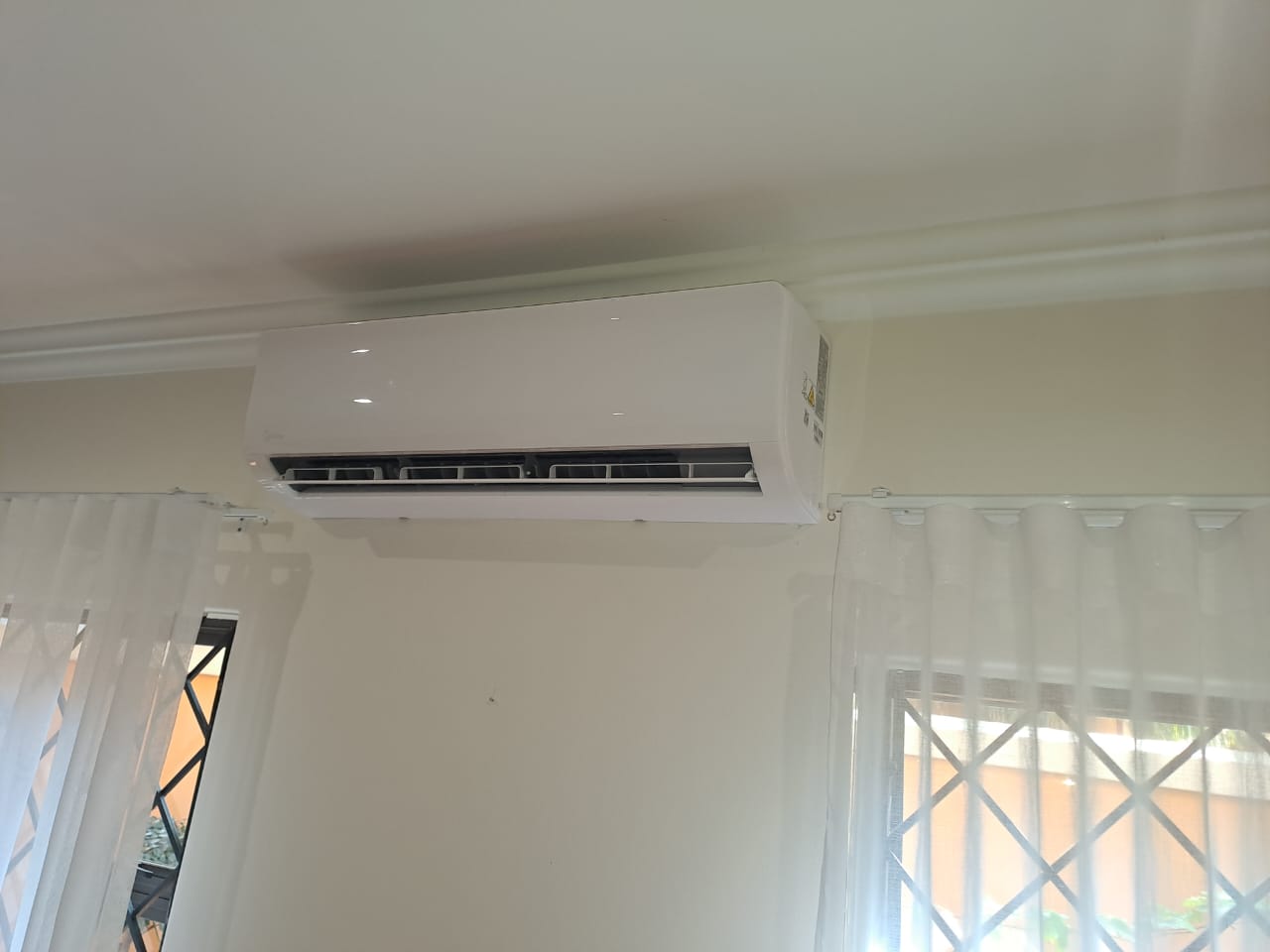 Indoor wall-mounted split unit air conditioner installed in residential home living room